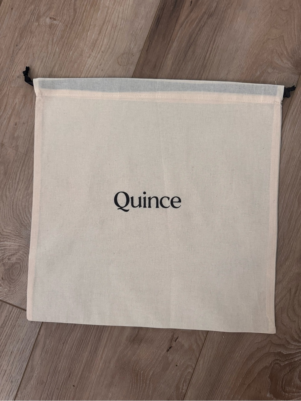 Quince Canvas Drawstring Pouch in Cream with Black Logo